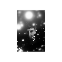 Portrait shot on Revolog Snovlox 35mm film featuring a black and white subject with a snowy, speckled light effect.