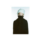 Portrait of a person wearing a white headwrap, featuring the Revolog Texture film's signature bubble pattern effect.