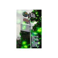 Gas station sign captured on 35mm film with a glowing green orb effect scattered across the frame.
