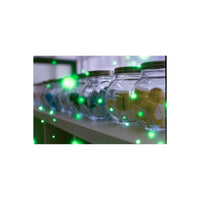 REVOLOG Volvox 35mm film canisters inside glass jars with a glowing green orb special effect overlay.