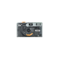 Reto PANO 35mm film camera in a compact, clear plastic body with a 22mm wide-angle lens and manual controls.