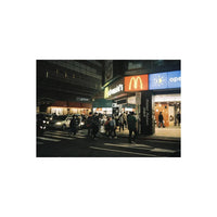 Street scene at night captured on RetoColor Glow 400 film with warm vintage tones and soft cinematic lighting.