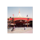 Carousel at a theme park captured on RetoColor Maple 100 film with a distinct cyan-blue cast and vibrant red accents.
