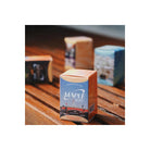 A boxed film canister labeled MAPLE 100 stands on a wooden table, with other blurred boxes in the background.