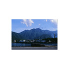 Vibrant landscape shot on RetoColor Mosaic 100 35mm film showing a coastal town, calm blue water, and majestic mountains.