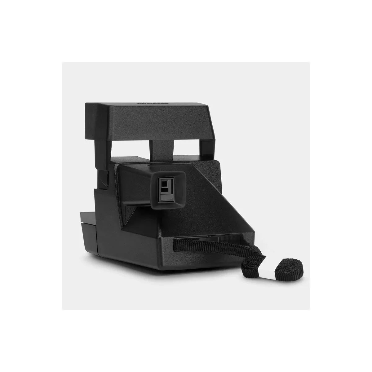 Black Retrospekt Polaroid 600 instant camera with a compact, angular design and an attached black wrist strap.
