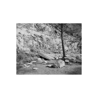 Black and white landscape photograph by Martin Zimelko depicting a rocky cliffside with scattered boulders, dry grass, and a solitary tree in the foreground.