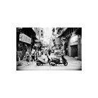 Black and white street scene featuring two parked scooters on a narrow city alleyway with pedestrians and storefronts.