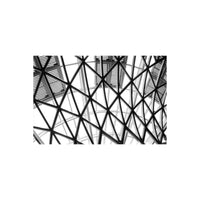 Black and white architectural shot of a geometric metal roof structure with high contrast and sharp detail.