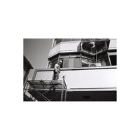 Person on a ladder against a building facade