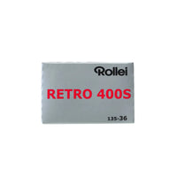 Silver box of Rollei Retro 400S 35mm black and white film with red text and 135-36 exposure count on a white background.