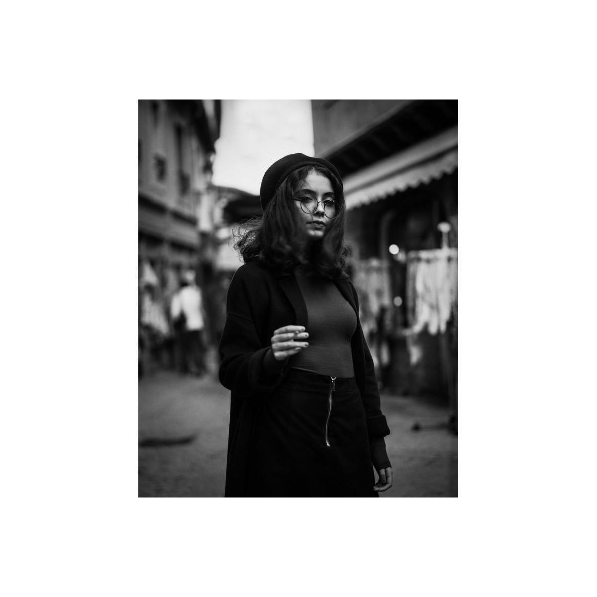 Black and white portrait of a woman in a beret and glasses, captured with fine-grain Rollei Retro 80S 35mm film.