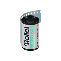 Rollei Retro 80S 35mm black and white film canister with a white label and exposed film leader on a white background.