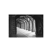 High-contrast black and white architectural shot of a brick arched tunnel captured on Rollei Superpan 200 35mm film.