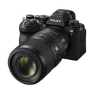 Sony FE 100mm f/2.8 Macro GM lens attached to a black Sony Alpha mirrorless camera body.