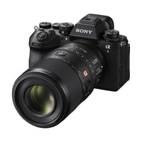 Sony FE 100mm f/2.8 Macro GM lens attached to a black Sony Alpha mirrorless camera body.