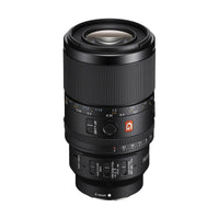 Black Sony FE 100mm f/2.8 GM macro lens with focus ring, aperture dial, and G Master branding on a white background.
