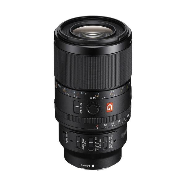 Black Sony FE 100mm f/2.8 GM macro lens with focus ring, aperture dial, and G Master branding on a white background.