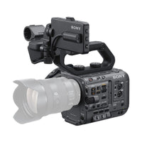 Sony FX6 cinema camera body in matte black with a top handle, side control panel, and attached lens on white background.