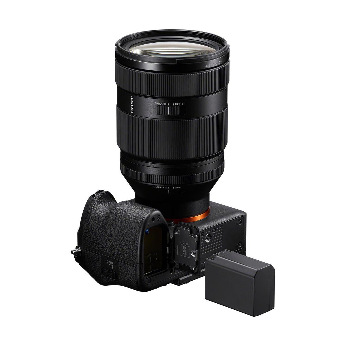 Black Sony NP-SA100 lithium-ion battery placed next to a mirrorless camera with an open battery compartment.
