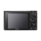 Back view of black Sony RX100 VII camera featuring a large LCD screen, control dial, and dedicated movie recording button.