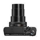 Top view of black Sony RX100 VII digital camera with extended ZEISS lens, mode dial, and compact metal body design.