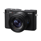 Compact black Sony RX1R III digital camera with a fixed ZEISS Sonnar 35mm f/2 lens and top-mounted control dials.