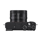 Top view of black Sony RX1R III camera with fixed ZEISS 35mm lens, mode dial, and exposure compensation dial.
