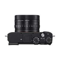 Top view of black Sony RX1R III camera with fixed ZEISS 35mm lens, mode dial, and exposure compensation dial.