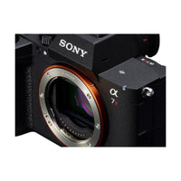 Black Sony a7R VI mirrorless camera body with orange E-mount ring and visible sensor detail.
