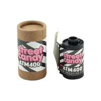Street Candy ATM 400 35mm black and white film roll next to its branded cardboard storage canister.