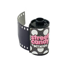 Street Candy MTN 100 35mm black and white film canister with a polka dot label and pink logo on a white background.
