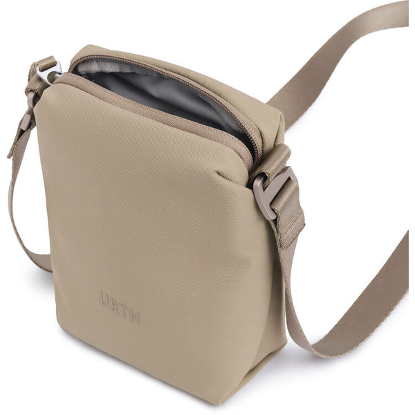 Beige crossbody bag with 'Urth' branding on a white background