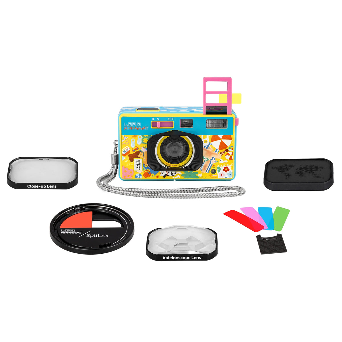 A colorful disposable camera with a cartoon character print, shown with its accessories on a white background, including a close-up lens, splitter lens, k-fold lens, filter, and protective case.