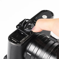 Camera lens with a hand adjusting a component on a white background