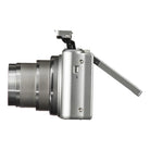 Digital camera with lens and flip-out screen on a white background