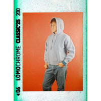 Person wearing a gray hoodie on an orange background with 'Lomochrome Classics' text.