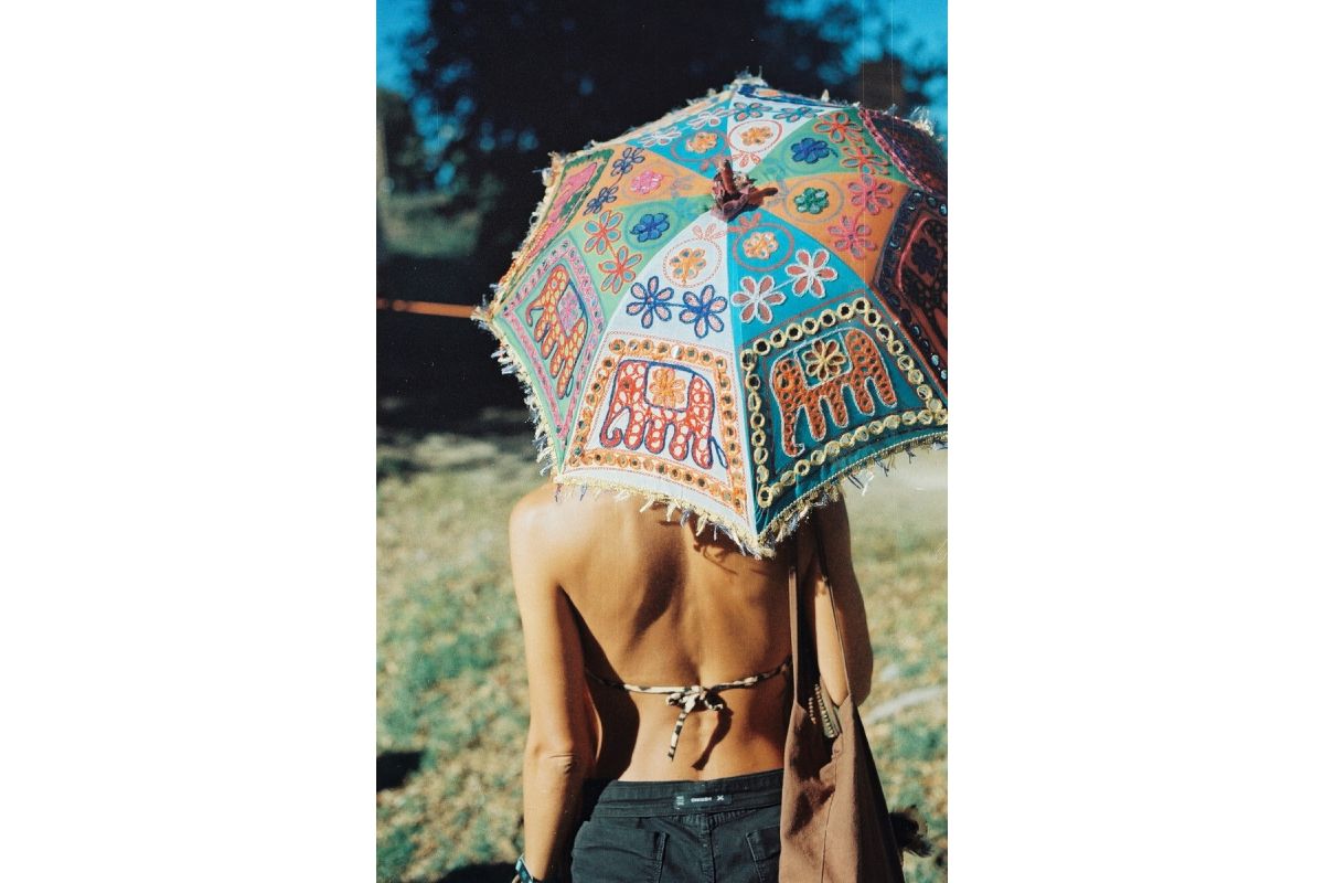Person holding a colorful umbrella outdoors