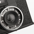 Close-up of a vintage camera with 'Black Jack' branding on the lens.
