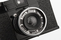 Close-up of a vintage camera with 'Black Jack' branding on the lens.