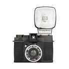 A black Lomography Diana F+ medium format camera with a flash attached to the top, viewed from the front.