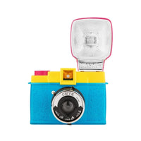 A colorful Lomography Diana F+ camera with a flash attachment and colored gel filters.