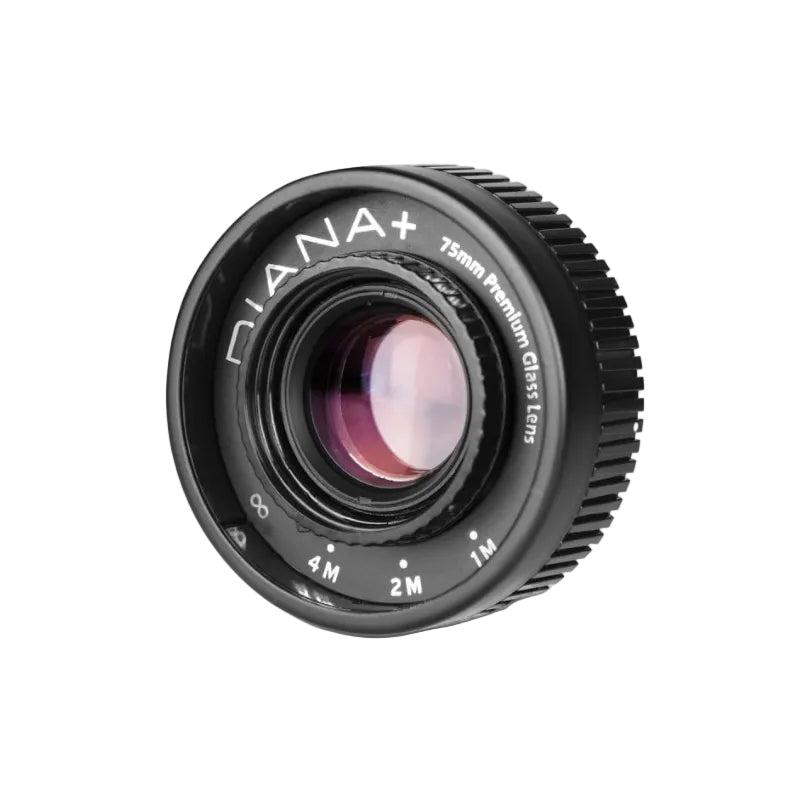 A black Niana+ 75mm f/2.8 Premium Glass Epos camera lens with white lettering, shown at a three-quarter angle on a light gray background.