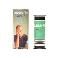 Two spools of bubblefilm film, labeled 'dubblefilm APOLLO 200', shown on a plain white background. One spool is wrapped in a light sage green paper sleeve featuring a photo of a man, and the other is wrapped in a light green paper sleeve with a barcode pattern at the bottom.