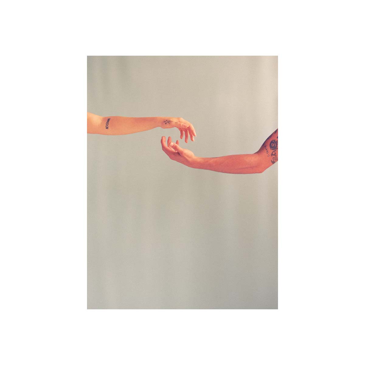 A minimalist art print featuring two human arms reaching toward each other against a plain light gray background, styled like a poster with a white border.