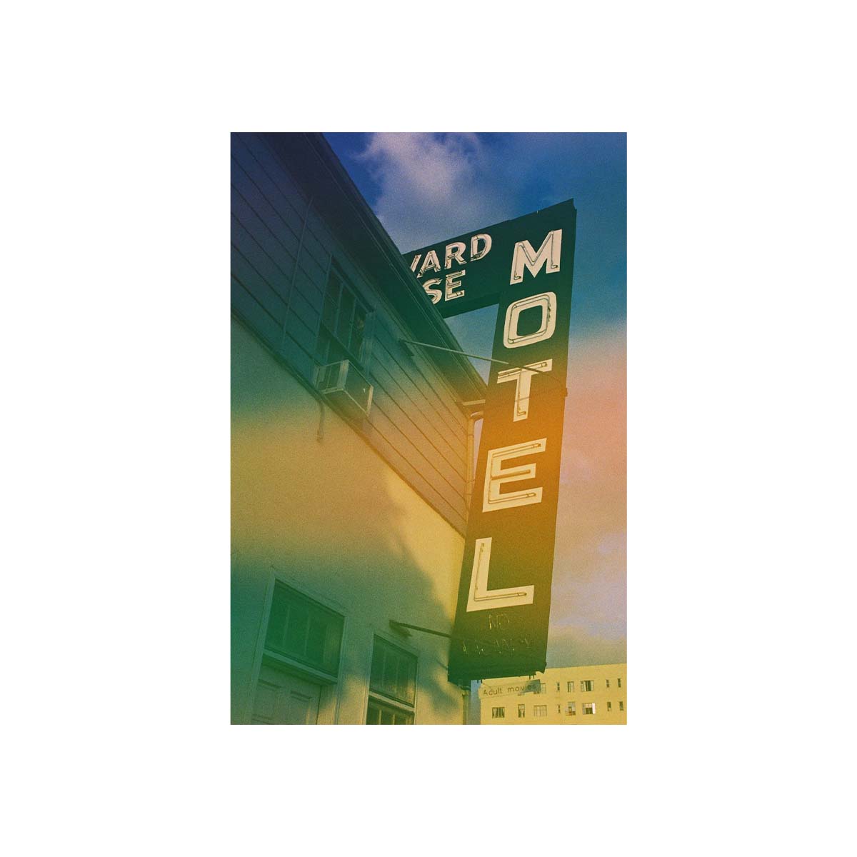 A vertical rectangular art print showing a vintage motel sign on a building against a blue sky with warm sunset tones, centered on a white background.