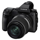 A black Fujifilm mirrorless camera body with a zoom lens, shown from a three-quarters angle on a solid white background.
