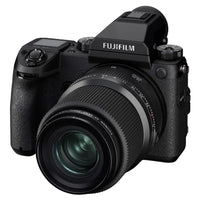 A black Fujifilm mirrorless camera body with a zoom lens, shown from a three-quarters angle on a solid white background.