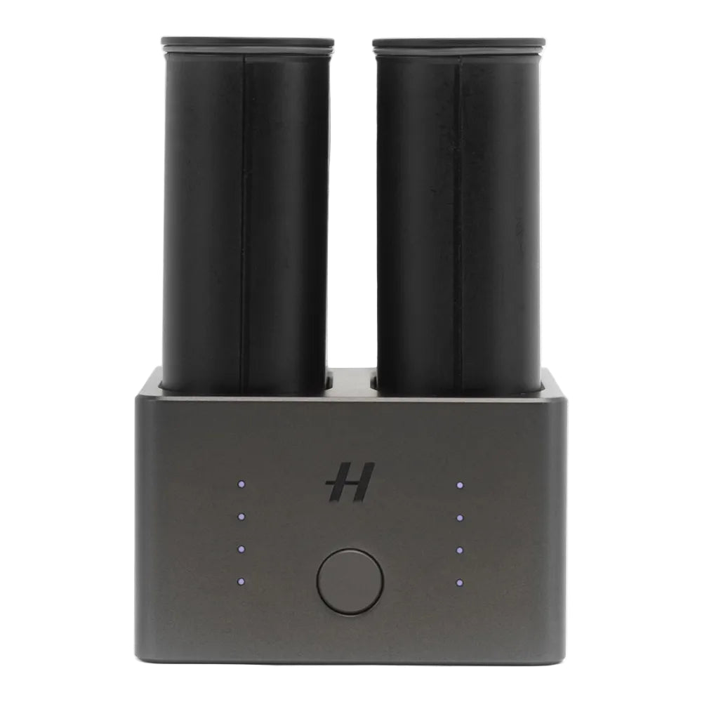 Black electronic device with two cylindrical components on a white background