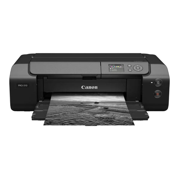 A Canon PIXMA PRO-310 all-in-one ink printer in black, shown from a front-facing angle with a black-and-white landscape photograph emerging from its paper tray against a solid white background.
